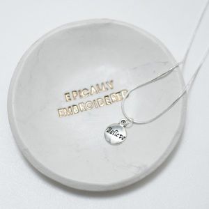22 inch silver charm necklace that says believe.
